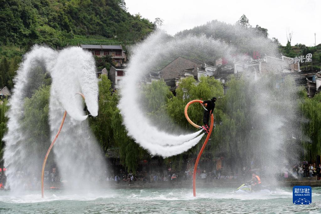 鎮遠古城にある?陽河で水上飛行パフォーマンスを披露するパフォーマーたち（6月17日撮影?楊楹）。